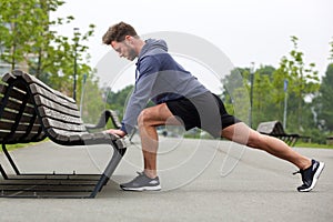 Healthy man doing stretch before jog