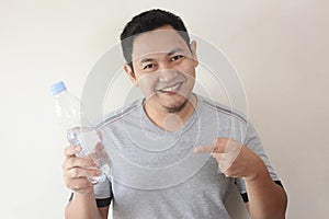 Healthy Man Drink Mineral Water in Bottle