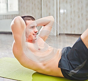 Healthy Man Exercising Abdominals On Foor.