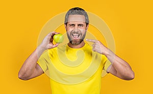 healthy man pointing on vitamin fruit on background. healthy man with vitamin fruit