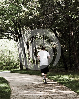 Healthy man running in the s-curved pathway in park near Dallas, Texas