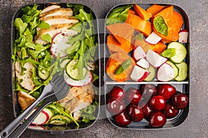 Healthy meal prep containers with grilled chicken with salad, sw
