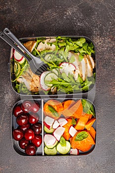 Healthy meal prep containers with grilled chicken with salad, sw