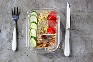 Healthy meal prep containers with quinoa, chicken and arugula