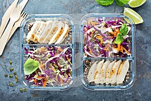 Healthy meal prep containers with quinoa and chicken photo