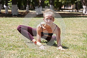 Healthy middle aged woman doing fitness stretching outdoors