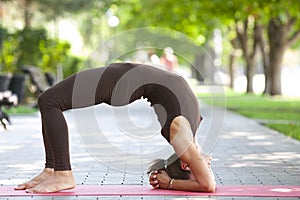 Healthy middle aged woman doing fitness stretching outdoors