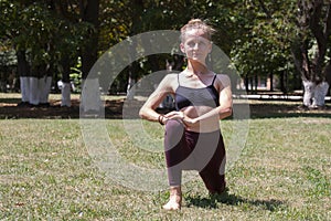 Healthy middle aged woman doing fitness stretching outdoors