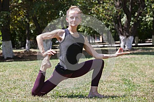 Healthy middle aged woman doing fitness stretching outdoors