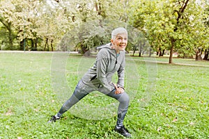 Healthy Middle Aged Woman Stretching Exercise In Nature