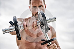 Healthy mind in a healthy body. Muscular man exercising with dumbbell. Dumbbell exercise. Dare to be great. Sportsman