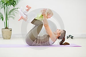 Healthy mother and baby making gymnastics