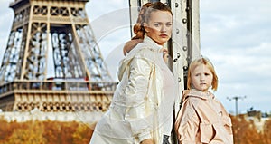 Healthy mother and child standing on Pont de Bir-Hakeim bridge
