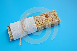 Healthy munchies  on blue background. cereal bar on a blue background