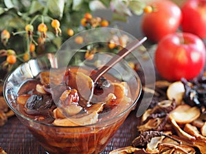 Healthy natural dessert on the background of dried fruits, fresh apples and rose hips.Homemade fruit jelly made with starch and