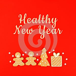 Healthy New Year`s Christmas set of ginger biscuits - man, house, tree glazed sugar icing decoration on blue background, minimal