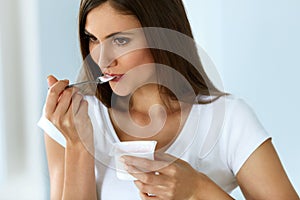 Healthy Nutrition. Beautiful Woman Eating Yogurt, Dairy Product