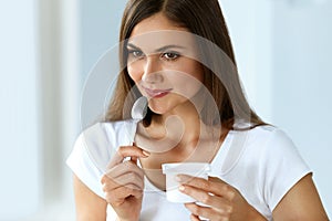 Healthy Nutrition. Beautiful Woman Eating Yogurt, Dairy Product