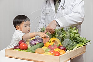 Healthy and nutrition concept. Kid learning about nutrition with doctor to choose eating fresh fruits and vegetables