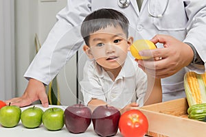 Healthy and nutrition concept. Kid learning about nutrition with doctor to choose eating fresh fruits and vegetables