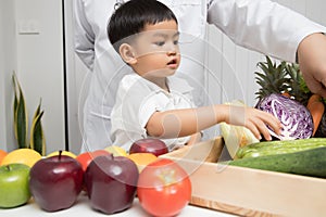 Healthy and nutrition concept. Kid learning about nutrition with doctor to choose eating fresh fruits and vegetables