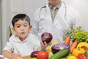 Healthy and nutrition concept. Kid learning about nutrition with doctor to choose eating fresh fruits and vegetables. Young asian