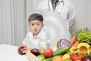 Healthy and nutrition concept. Kid learning about nutrition with doctor to choose how to eat fresh fruits and vegetables