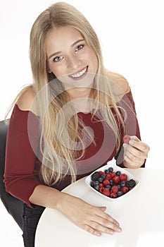 Healthy nutrition - She eats a bowl of fruit salad