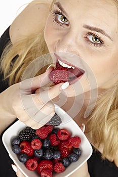 Healthy nutrition - She eats a bowl of fruit salad