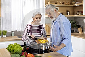 Healthy Nutrition. Happy Senior Couple Preparing Vegetable Meal Together In Kitchen