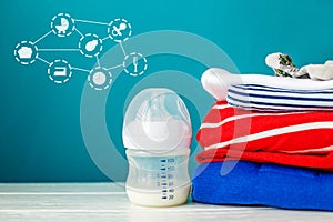 Healthy nutrition for newborns in bottle and clothing. Concept of newborns, motherhood, care, lifestyle