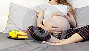 Healthy Nutrition During Pregnancy. Concept of expectation of the child, pregnancy and motherhood. Young pregnant woman sits at