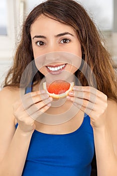 Healthy nutrition woman eating grapefruit