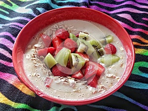 Healthy nutritious fruity breakfast on colorful zebra blanket