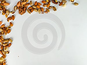Healthy and nutritious organic nut mix presenting a healthy diet and forming an interesting frame on a white surface