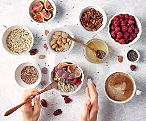 Healthy oatmeal breakfast with raspberries and finns, chia and flax seeds and honey, pattern, top visas, good morning concept