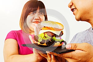 Fat young Asian couple wants to lose weight alone, obese woman refuses to eat hamburgers.