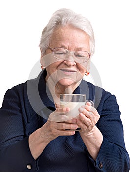 Healthy old woman holding a glass of milk