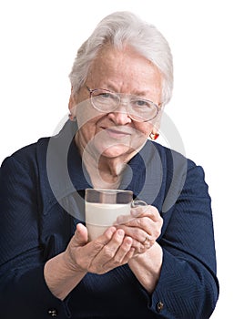 Healthy old woman holding a glass of milk