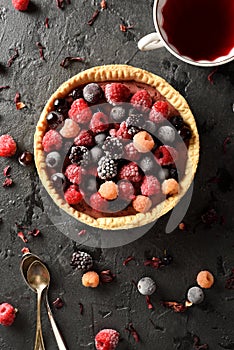 Healthy open pie with raw raspberries, blackberries and currants with tea