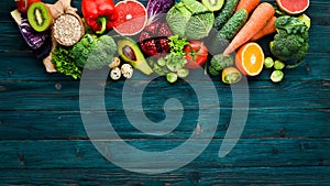 Healthy organic food on a blue wooden background. Vegetables and fruits.