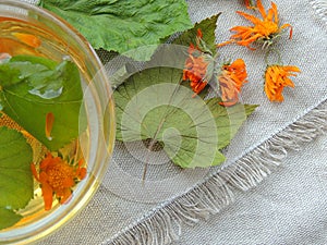 Healthy organic herbal tea with calendula and dry leaves of blackcurrant and mulberry.