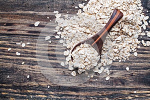 Healthy Organic Quick Oat Flakes in a Wooden Spoon