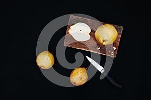 Healthy organic yellow pears on the desk. Fruit background. Ripe fresh organic pears on black background. Pear autumn harvest. Sli