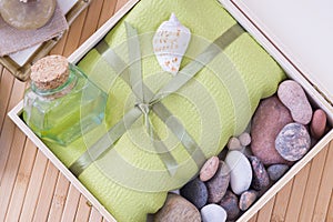 Healthy outfit for relaxation and SPA procedures with towel, stones and body oil