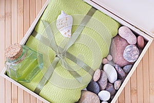 Healthy outfit for relaxation and SPA procedures with towel, stones and body oil