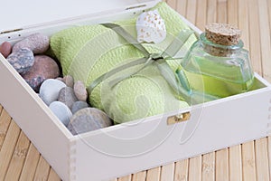 Healthy outfit for relaxation and SPA procedures with towel, stones and body oil