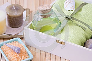 Healthy outfit for relaxation and SPA procedures with towel, stones and body oil