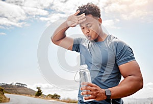 A healthy outside starts from the inside. Shot of a man drinking water while out for a workout.