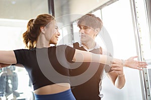Healthy people asian young woman sport exercise in fitness gym sport club with personal trainer instructors help support